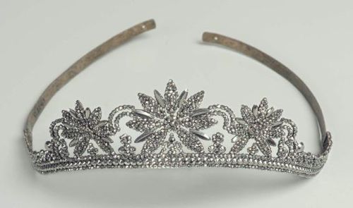 cut steel tiara with 3 flower like elements, the middle one larger than the side ones. 3 rows of cut steel beads on the bottom. Flower elements are separated by smaller floral designs and connected with semi-circular shapes