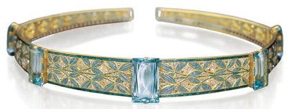 Simple gold band with engraved green leaves and 5 rectangular aquamarines spaced around the band.