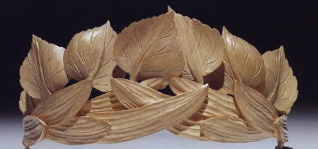 Tiara carved of beechwood with a base of willow leaves on their sides and above that birch leaves with the stems in the willow leaves and pointing straight up.