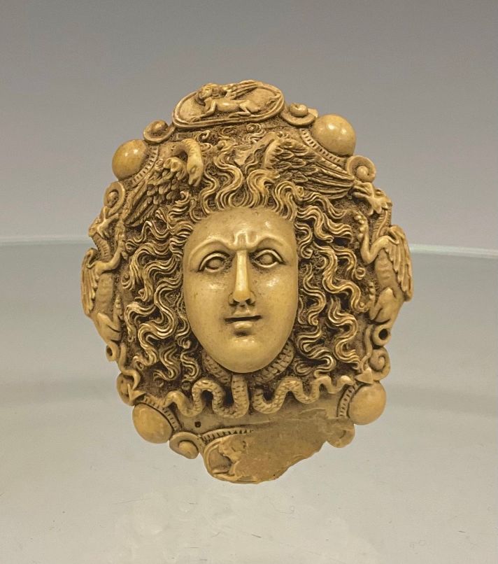 example of a 19th century lava cameo carved in the shape of a medusa head