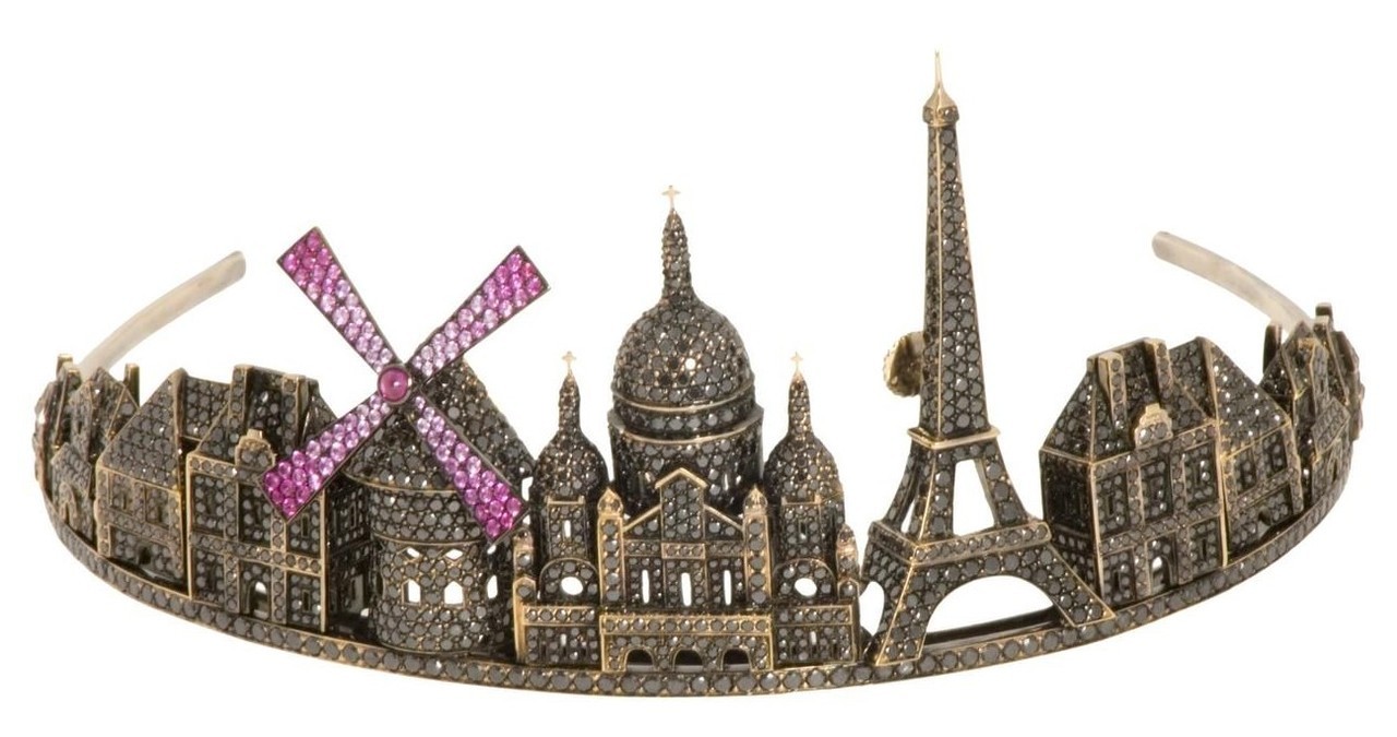 Tiara made of black gold featuring famous buildings in Paris including the Eiffel Tower, the Moulin Rouge and the Sacre-Coeur. The buildings are studded with black diamonds and rubies.