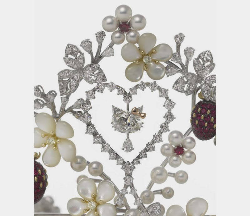 Close up of the central element of the Hello Tiara, a figure made of diamonds hanging from the center of a heart.