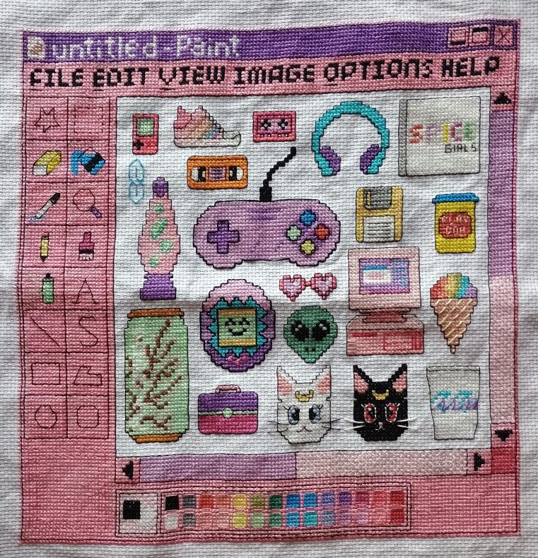 cross stitch item showing a Paint-like window with 90's motif items inside. Items are: Gameboy, multicolored high-top sneaker, cassette tape, VHS tape, headphones, Spice Girl CD, 3 1/2 inch floppy disk, can of Play Doh, a stylized S, lava lamp, game controller, multicolored ice cream scoop in waffle cone, pink old-style computer, heart-shaped sunglasses, alien head, tamagotchi, can of Arizona iced tea, Caboodle makeup holder, one white and one black cat head, each one with half-moons on the forehead, a paper Dixie cup with blue and purple decorative lines in the middle. There are scroll bars on the bottom and right side. On the top are options: File, Edit, View, Images, Options, Help. The first letter in each word is underlined. Above that is the purple title bar which says, 