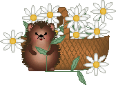 hedgehog standing in front of a brown basket full of daisies. It is holding the stem of one of the flowers. One daisy has fallen out of the basket and is on the ground to the right of the hedgehog.