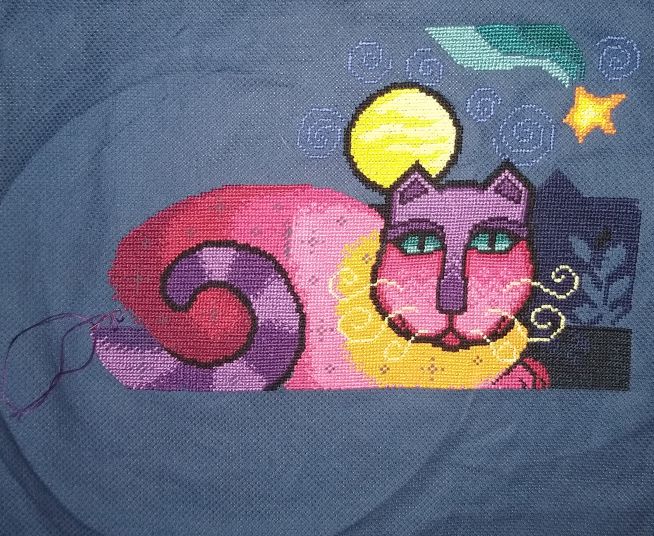 colorful cross stitch cat on dark blue background