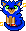 Blue kitty made to look like Sonic the Hedgehog. He has green eyes; a yellow muzzle, inner ears, legs and chest; and is wearing red sneakers.